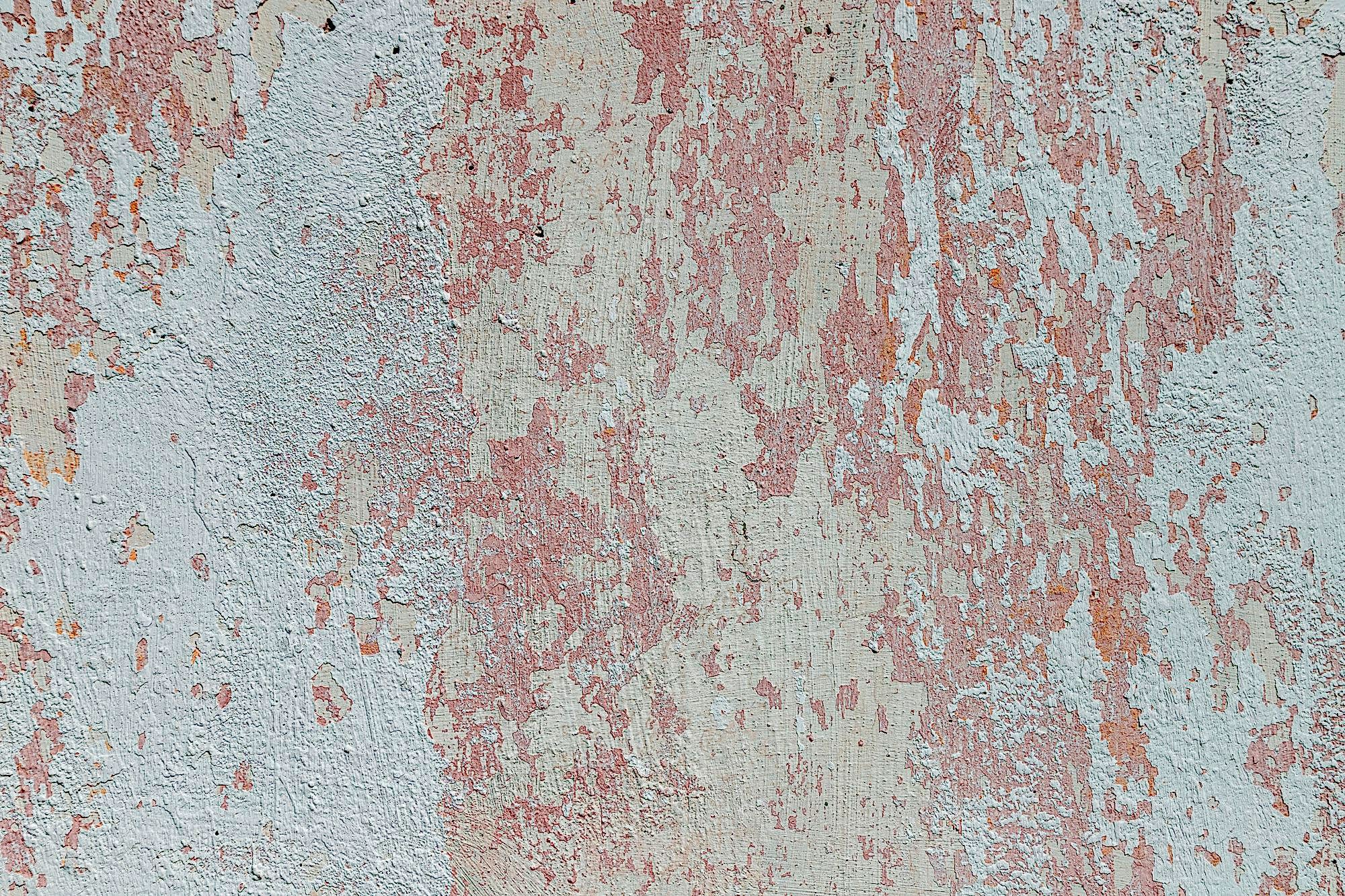 Peeling whitewash on a plaster wall